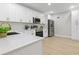 Modern kitchen with white cabinets, stainless steel appliances, and quartz countertops at 400 Avenue B Ne, Winter Haven, FL 33881