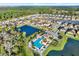 Aerial view of community pool, lake, and homes at 4310 Trotters Way, Lakeland, FL 33801