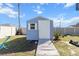 Blue shed with wooden walkway, providing extra storage space at 2986 Sw 143Rd Place Rd, Ocala, FL 34473
