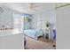 Serene bedroom with a twin bed, floating shelves, and a desk at 2986 Sw 143Rd Place Rd, Ocala, FL 34473