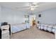 Spacious bedroom with twin beds and an open view to another room at 2986 Sw 143Rd Place Rd, Ocala, FL 34473