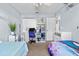 Bright bedroom with twin beds, desk, and ample closet space at 2986 Sw 143Rd Place Rd, Ocala, FL 34473