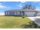 Charming one-story home with a two-car garage and lush lawn at 2986 Sw 143Rd Place Rd, Ocala, FL 34473