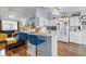 Open kitchen with breakfast bar, white cabinetry, and wood floors at 2986 Sw 143Rd Place Rd, Ocala, FL 34473