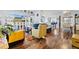 Open concept living space with hardwood floors, comfy seating, and a large TV at 2986 Sw 143Rd Place Rd, Ocala, FL 34473