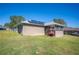 Home exterior showcasing solar panels and a sunroom addition at 930 Chelsea Way, Lake Wales, FL 33853