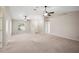 Large living room with high ceilings, neutral walls, and ceiling fans at 930 Chelsea Way, Lake Wales, FL 33853