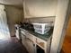 View of a small kitchen with stove, sink and cabinets at 1228 35Th Nw St, Winter Haven, FL 33881