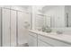 Bathroom boasts a double vanity, a large mirror, and a walk-in shower at 5822 Le Marin Way, Kissimmee, FL 34758