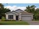 Attractive one-story home with gray siding, landscaping, and a two-car garage at 689 Peroni Ave, Debary, FL 32713