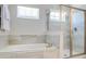 Modern bathroom with a soaking tub and walk-in shower, featuring neutral tones at 7650 Fairfax Dr, Kissimmee, FL 34747