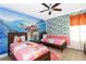 Themed bedroom with twin beds and ocean mural at 7650 Fairfax Dr, Kissimmee, FL 34747