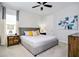 Main bedroom with plush bed, nightstands, and art at 7650 Fairfax Dr, Kissimmee, FL 34747