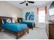 Cozy bedroom with twin beds, ideal for guests, featuring modern decor and ample natural light at 7650 Fairfax Dr, Kissimmee, FL 34747