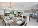 Spacious dining area with large table and modern chandelier at 7650 Fairfax Dr, Kissimmee, FL 34747