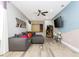 Game room with sectional sofa, arcade game, and large screen TV at 7650 Fairfax Dr, Kissimmee, FL 34747