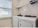 Bright laundry room, featuring washer, dryer, and storage at 7650 Fairfax Dr, Kissimmee, FL 34747