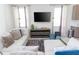Spacious living room with sectional sofa and large TV at 7650 Fairfax Dr, Kissimmee, FL 34747