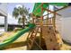 Wooden playset with slide, climbing wall, and shade at 7650 Fairfax Dr, Kissimmee, FL 34747