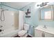 Clean bathroom with white vanity, bathtub, and light blue walls at 1540 Dolphin Dr, Lakeland, FL 33801