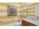 Small bathroom with yellow striped walls and a single vanity at 2003 Stake Out Way, Apopka, FL 32703