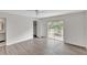Bright bedroom with wood-look flooring and access to private balcony at 7340 Daniel Webster Dr # 6, Winter Park, FL 32792