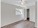 Bright bedroom with wood-look floors, a large window, and a spacious closet at 7340 Daniel Webster Dr # 6, Winter Park, FL 32792