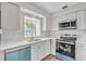 Renovated kitchen boasts modern white cabinets, stainless steel appliances, and quartz countertops at 7340 Daniel Webster Dr # 6, Winter Park, FL 32792