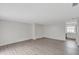 Open living room with wood-look flooring and view into the updated kitchen at 7340 Daniel Webster Dr # 6, Winter Park, FL 32792