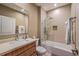 Bathroom with a soaking tub and modern vanity at 7482 Brooklyn Dr, Kissimmee, FL 34747