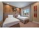 Bright bedroom with twin beds and wood-paneled accent wall at 7482 Brooklyn Dr, Kissimmee, FL 34747