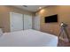 Main bedroom with a king-size bed and flat-screen TV at 7482 Brooklyn Dr, Kissimmee, FL 34747