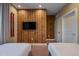 Bedroom featuring a wood-paneled accent wall and flat-screen TV at 7482 Brooklyn Dr, Kissimmee, FL 34747