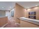 Upstairs hallway with carpet, artwork, and access to bedrooms at 7482 Brooklyn Dr, Kissimmee, FL 34747