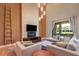 Spacious living room with a modern fireplace and large windows at 7482 Brooklyn Dr, Kissimmee, FL 34747