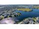 Aerial view showing neighborhood homes and lakefront property at 9406 Dugard Ct, Orlando, FL 32827