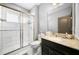 Bathroom with walk-in shower, granite countertop, and dark vanity at 9406 Dugard Ct, Orlando, FL 32827