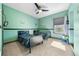 Bright bedroom with two twin beds, ceiling fan, and window at 9406 Dugard Ct, Orlando, FL 32827