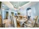 Elegant formal dining room with a large table, chandelier, and access to other rooms at 9406 Dugard Ct, Orlando, FL 32827