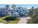 Two-story home with gray siding, blue shutters, and a paver driveway at 9406 Dugard Ct, Orlando, FL 32827