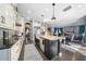 Open concept kitchen with island, stainless steel appliances, and view to living room at 9406 Dugard Ct, Orlando, FL 32827