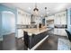 Gourmet kitchen boasts an island, custom cabinetry, and granite countertops at 9406 Dugard Ct, Orlando, FL 32827