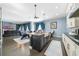 Open kitchen with large island, white cabinets, and dark countertops at 9406 Dugard Ct, Orlando, FL 32827