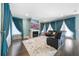 Spacious living room with a fireplace, hardwood floors, and large windows at 9406 Dugard Ct, Orlando, FL 32827