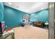 Home office with teal walls, a comfortable couch, and workspace at 9406 Dugard Ct, Orlando, FL 32827