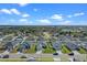 Aerial view of house and neighborhood, showcasing homes with solar panels at 524 Scenic Bluff Blvd, Lake Wales, FL 33853