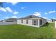 Backyard with screened enclosure and solar panels at 524 Scenic Bluff Blvd, Lake Wales, FL 33853