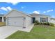 One-story home with a two-car garage and landscaped lawn at 524 Scenic Bluff Blvd, Lake Wales, FL 33853
