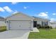 One-story home with a two-car garage and landscaped lawn at 524 Scenic Bluff Blvd, Lake Wales, FL 33853