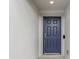 Modern front door with a sleek, dark blue finish at 524 Scenic Bluff Blvd, Lake Wales, FL 33853